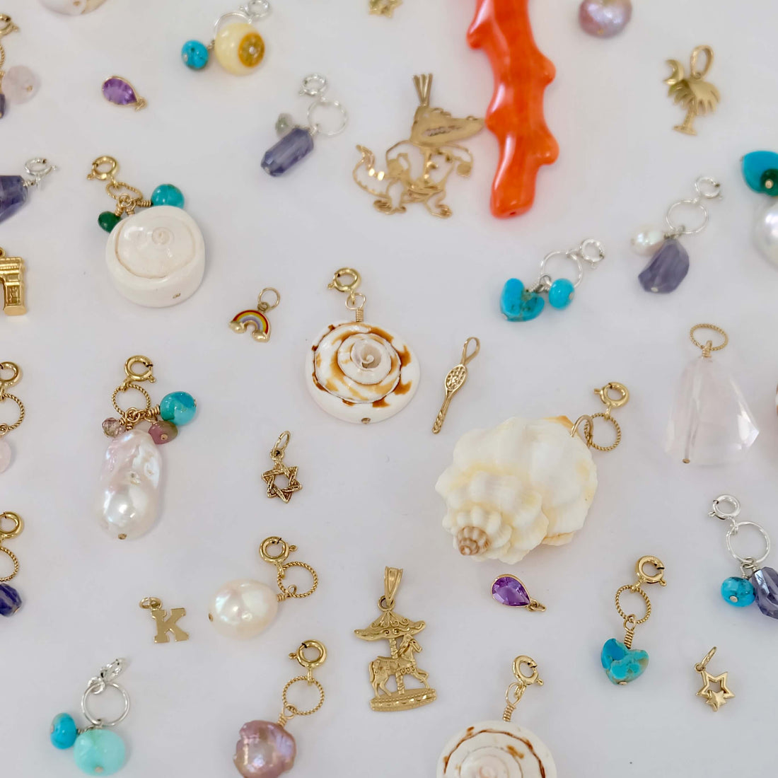 Collection of handcrafted silver and gold charms showcasing personalized designs and seasonal themes.
