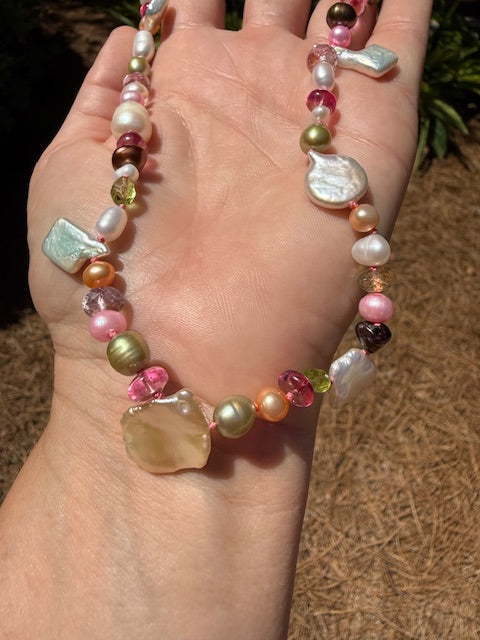 Close-up of pastel pearls and mixed gemstones on silk cord