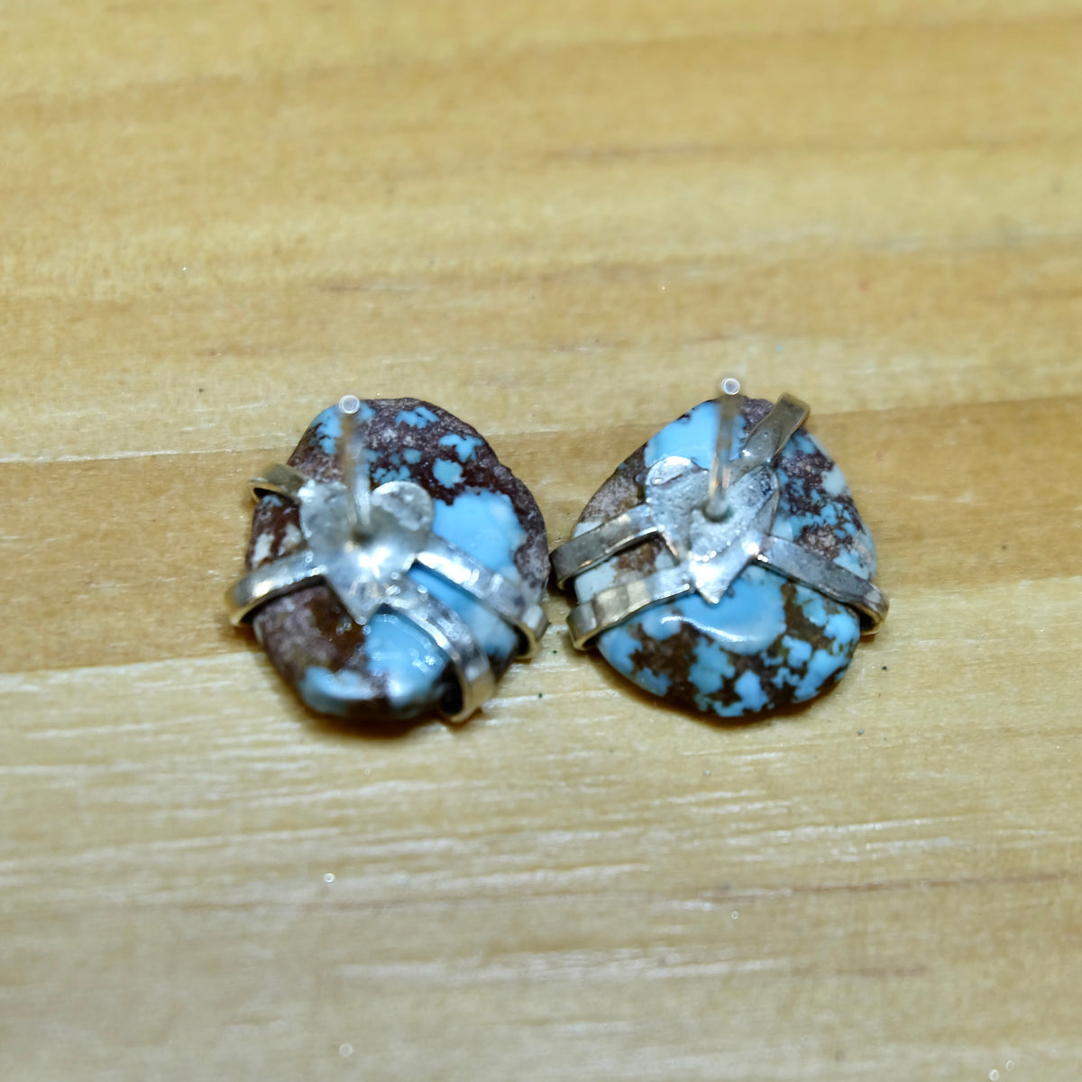 Golden Hills Turquoise Stud Earrings styled on a jewelry display in sterling silver