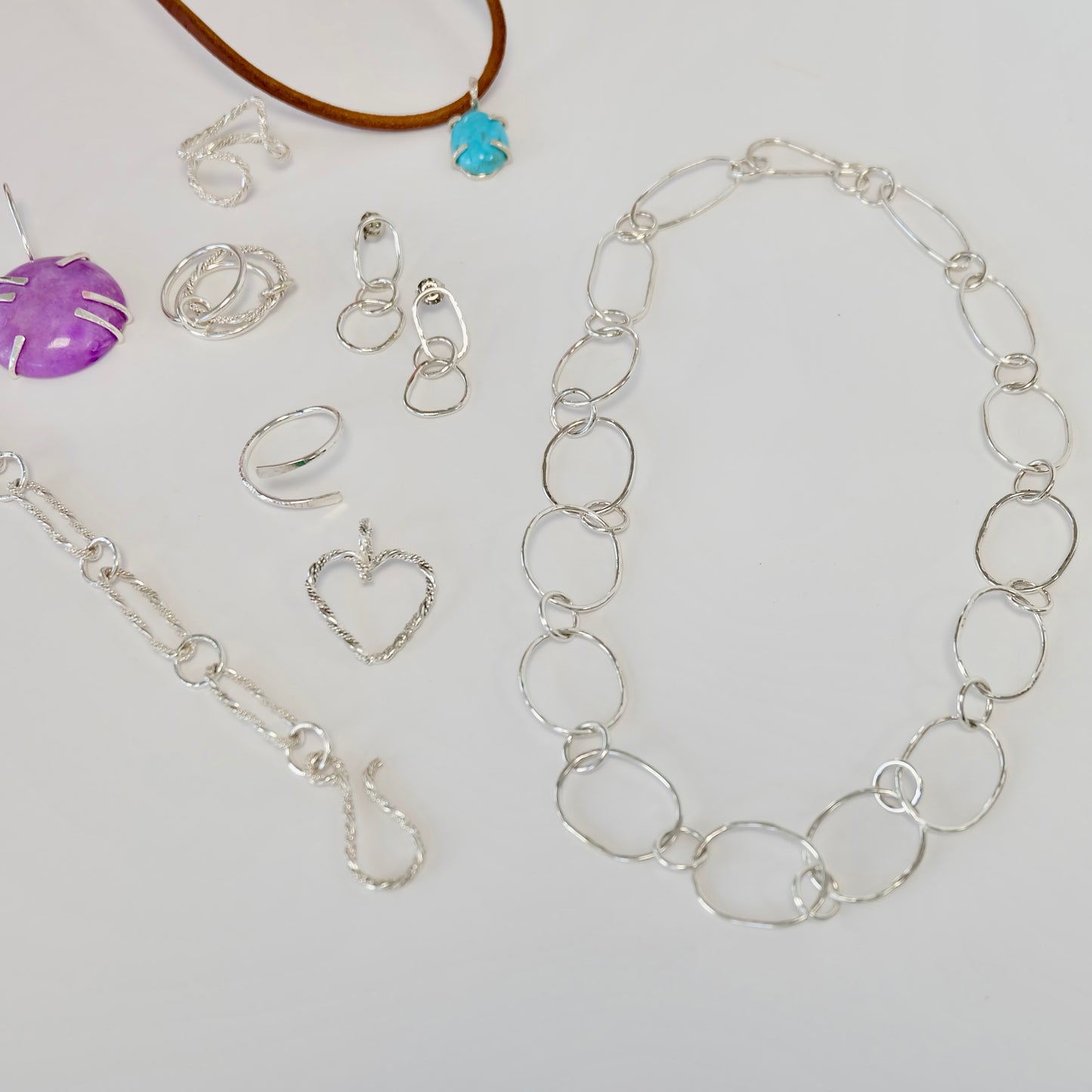 Elegant silver jewelry featuring intricate designs and a polished finish, perfect for any occasion.