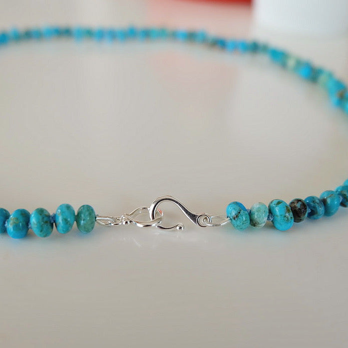 A fashionable turquoise beaded necklace, featuring a unique arrangement of beads, perfect for elevating your style.