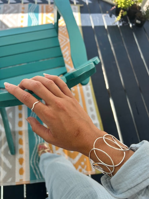Silver cuff bracelet with overlapping ovals, crafted in ethically sourced silver for a unique and elegant design that stands out.