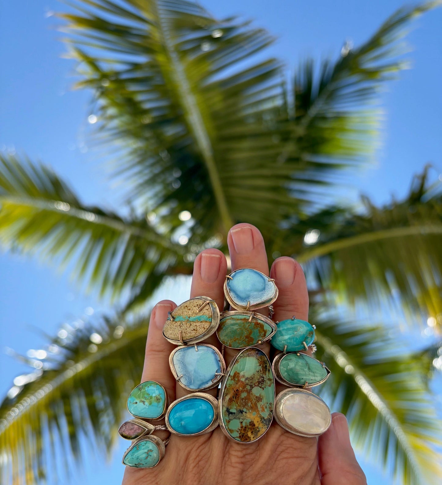 A collection of turquoise rings artistically arranged, showcasing vibrant blue hues and unique patterns.