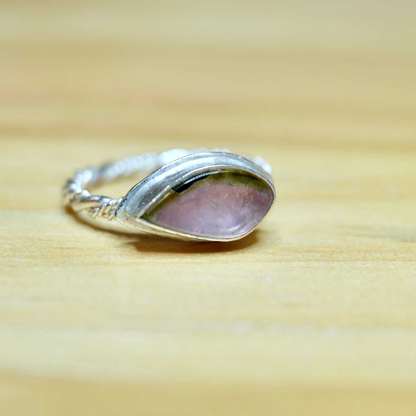 Watermelon tourmaline ring displaying a vibrant pink and green stone, set in a refined silver band for a sophisticated look.
