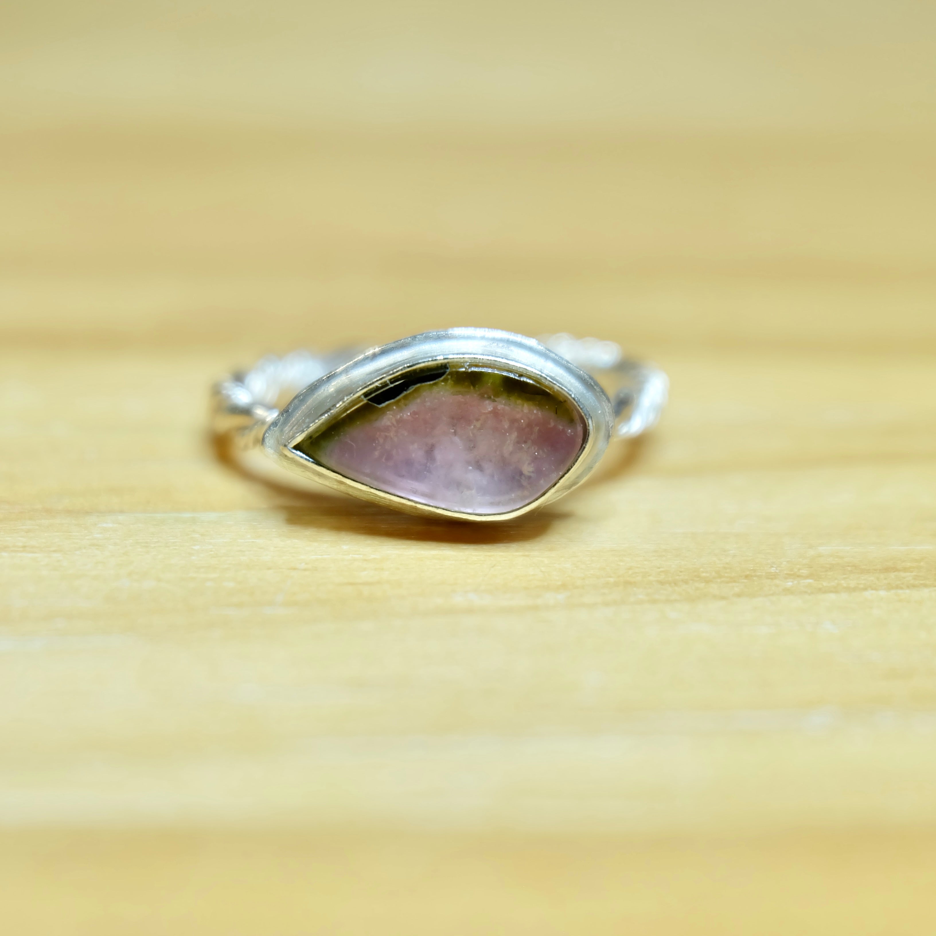 A beautiful watermelon tourmaline ring, size 6, with a striking pink and green gem, elegantly designed in a polished sterling silver band.