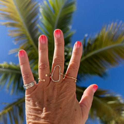 Elegant gold and silver stacking rings styled for a chic, modern look.