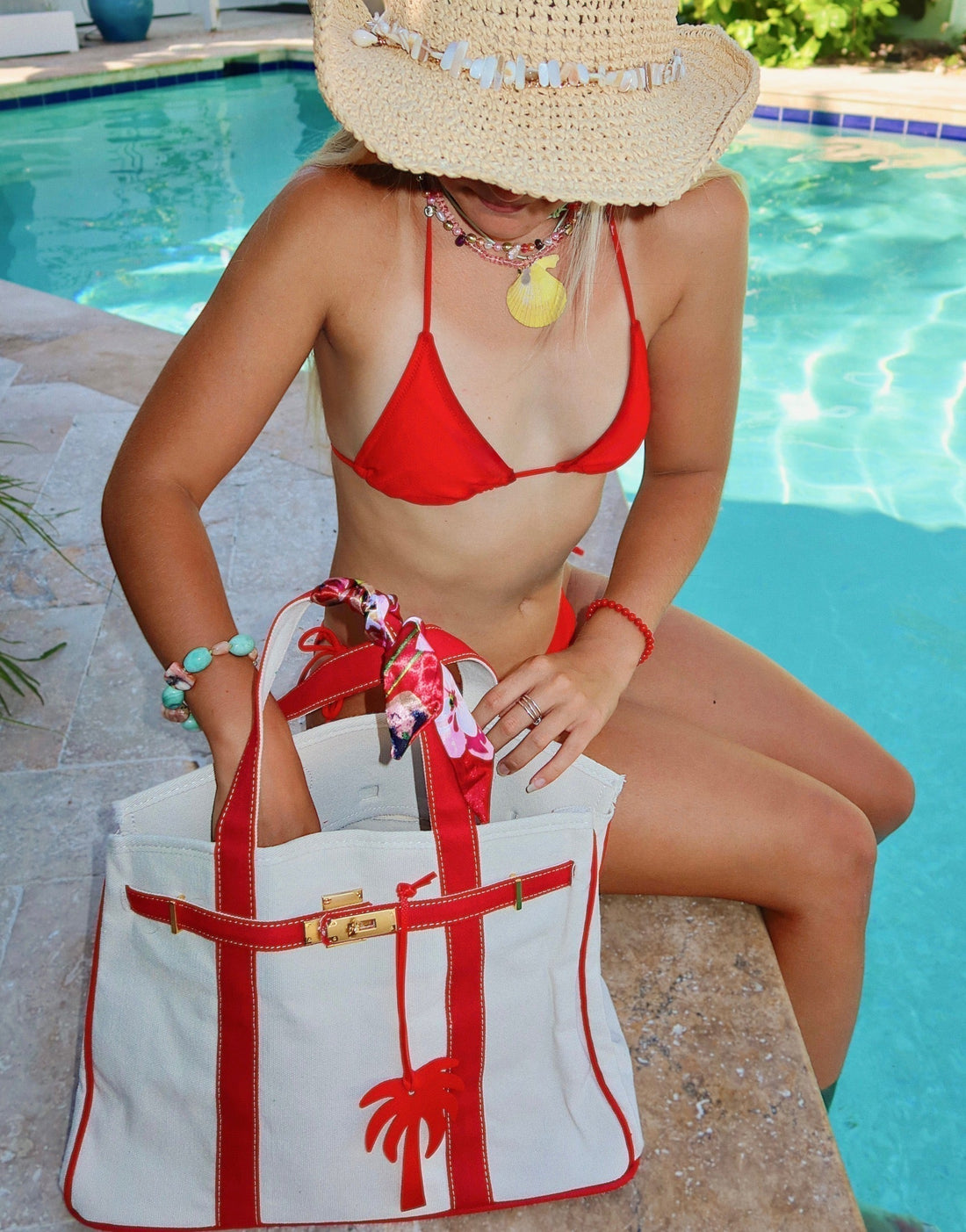 Boatkin bag in white with red trim and palm tree charm, poolside
