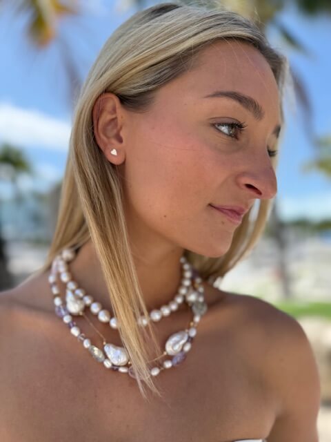 Woman wearing a collection of bridal jewelry