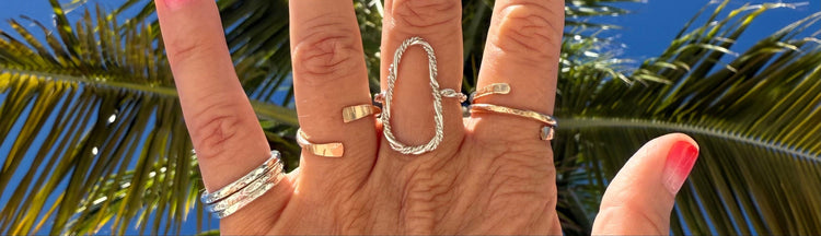 Elegant gold and silver stacking rings layered on a hand, showcasing a mix of textures and gemstones