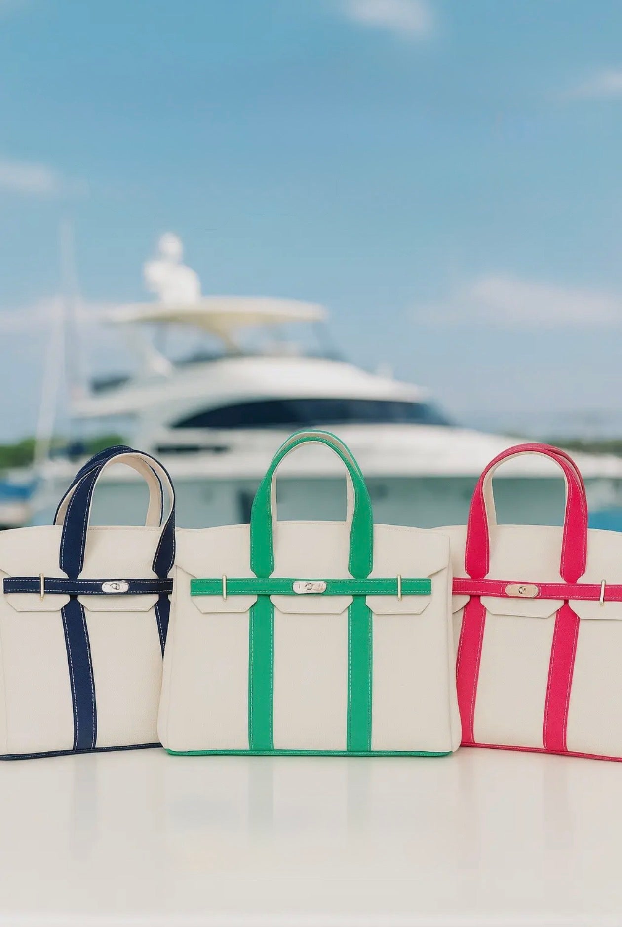Display of boat tote bags with blue, green and pink trim