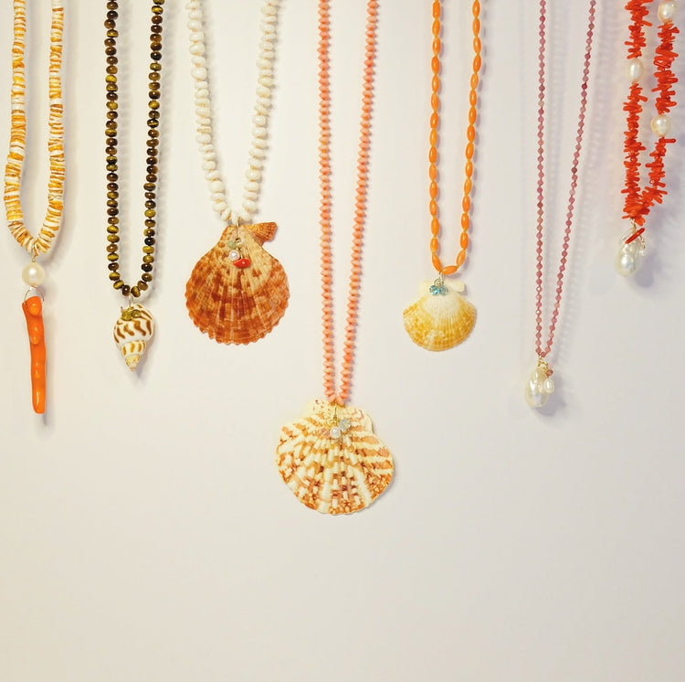 Beautiful beach jewelry showcasing delicate seashells and marine motifs, perfect for summer wear.