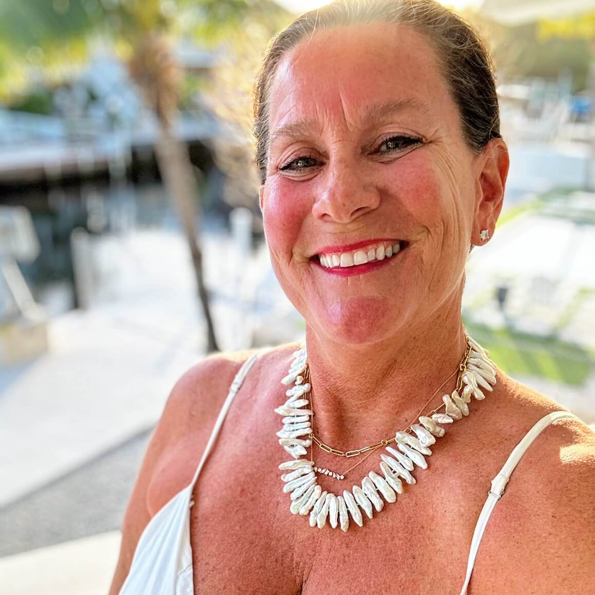 Woman wearing a Biwa pearl necklace featured on StyleBlueprint