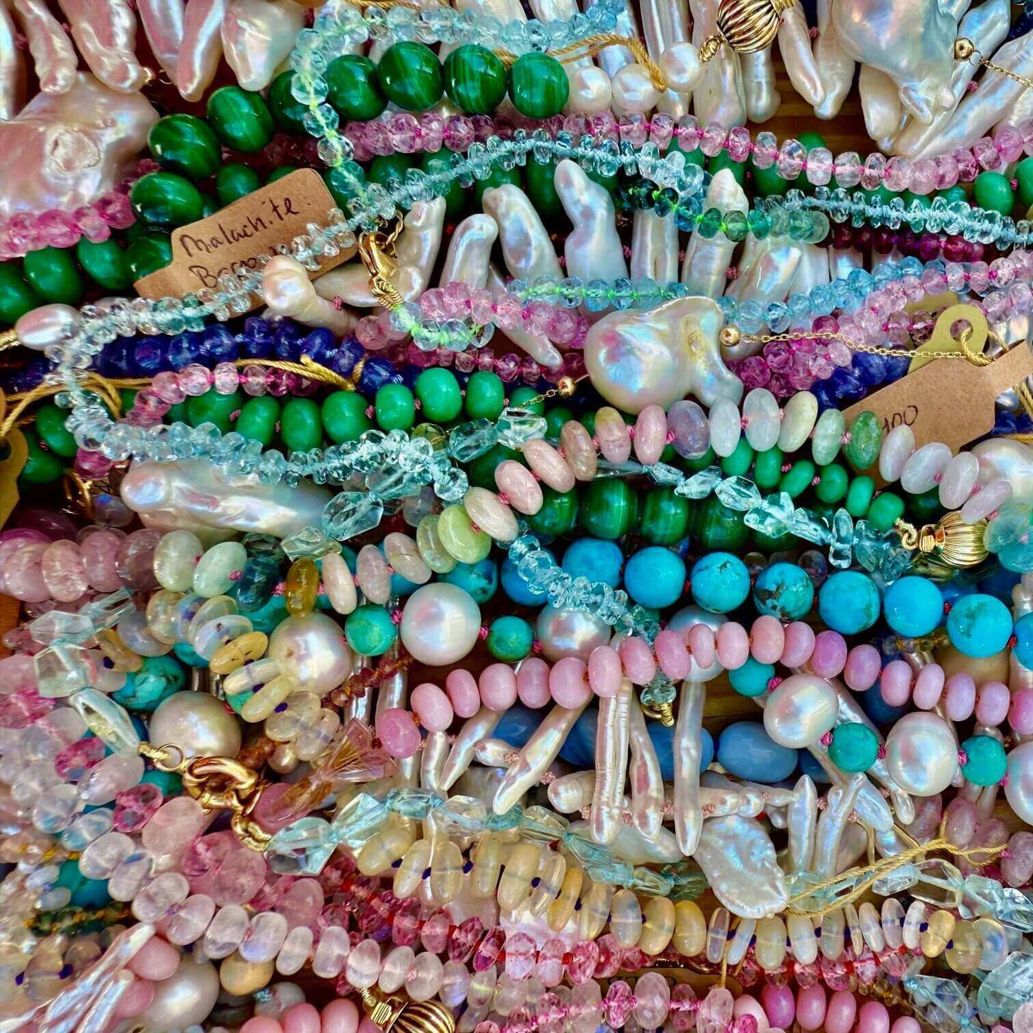 A collection of vibrant candy necklaces made of colorful beaded gemstones, displayed together to highlight their playful design.
