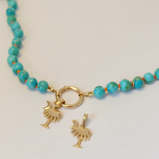 A beautiful 14K gold charm shaped like Charleston, showcasing intricate details and a shiny finish. Perfect for jewelry lovers!