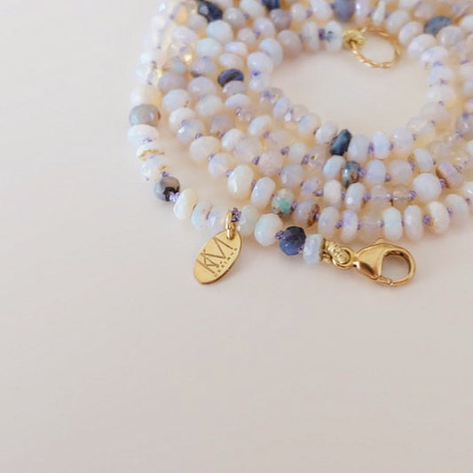 Australian opal candy necklace with 14k gold displayed on a neutral background.