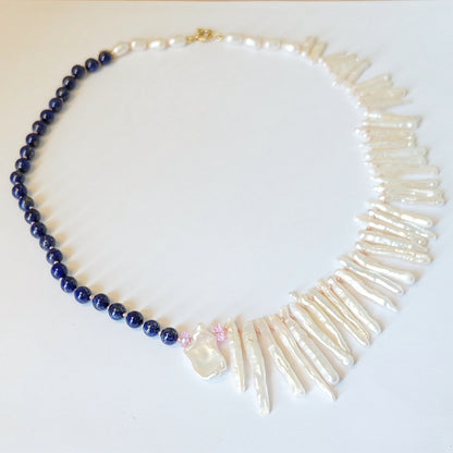 Close-up of lapis lazuli and pink topaz beads on a Biwa pearl necklace