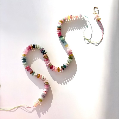 Colorful watermelon tourmaline beaded candy necklace in solid 14K gold on a white background.