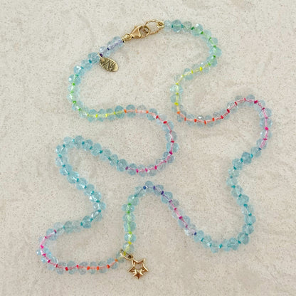 14K gold double star charm worn as a pendant