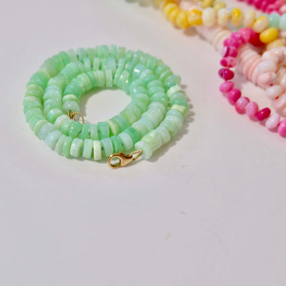 Close up of 14K gold-filled green opal candy necklace highlighting heishi beads and clasp.