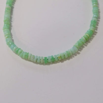 Profile view of a 14K gold-filled green opal candy necklace showing heishi-cut beads.