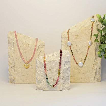 Display of 14K gold watermelon tourmaline bead necklaces