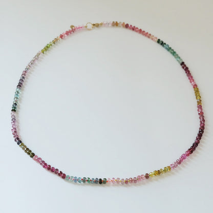 Full view of a 14K gold watermelon tourmaline candy necklace with pink and green gemstones.