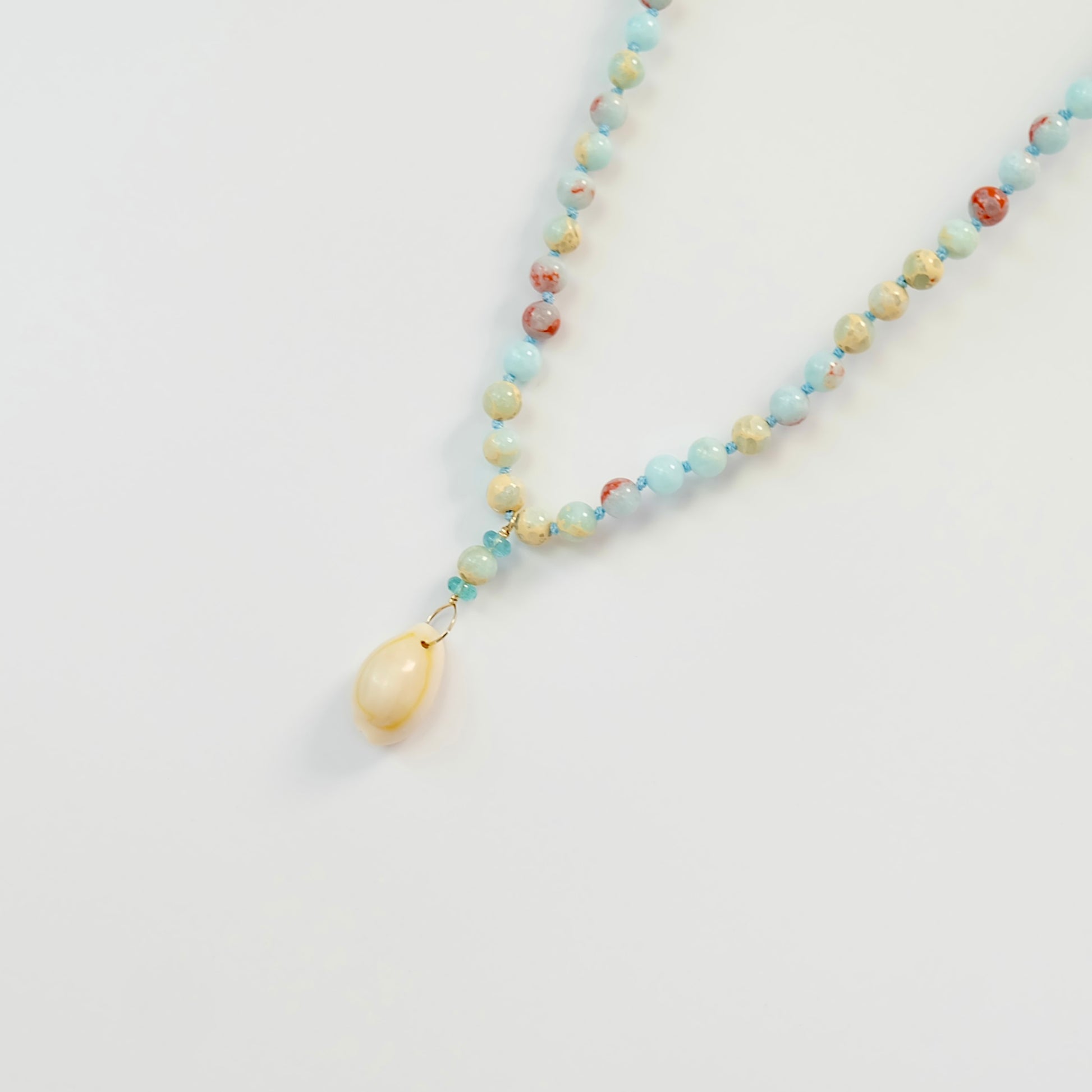 Discover the elegance of our hand knotted Agate Apatite Cowrie Shell Charm Necklace with a 14K gold filled clasp.