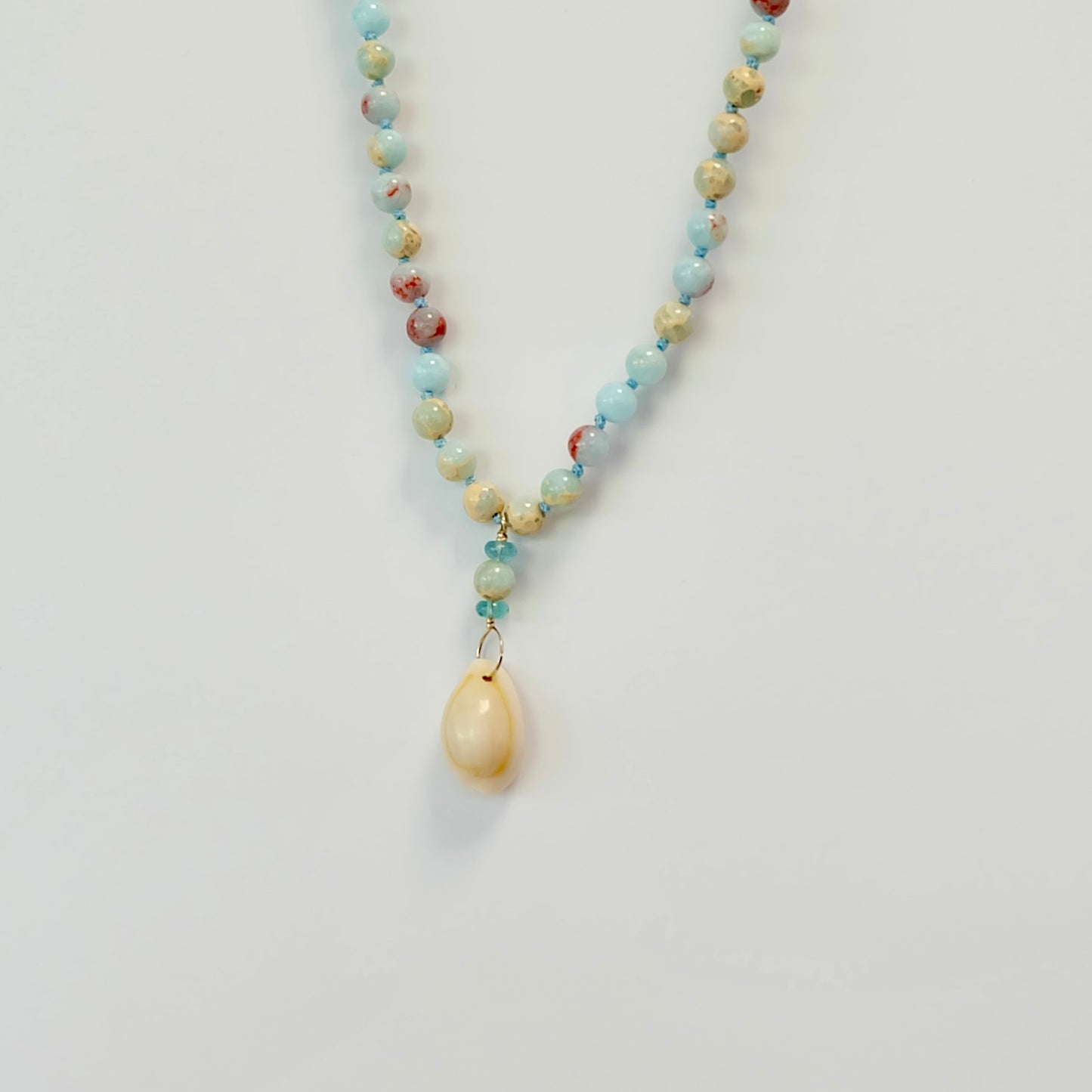 Hand knotted Agate Apatite Cowrie Shell Charm Necklace featuring an ethically sourced 14K gold filled clasp for elegance.