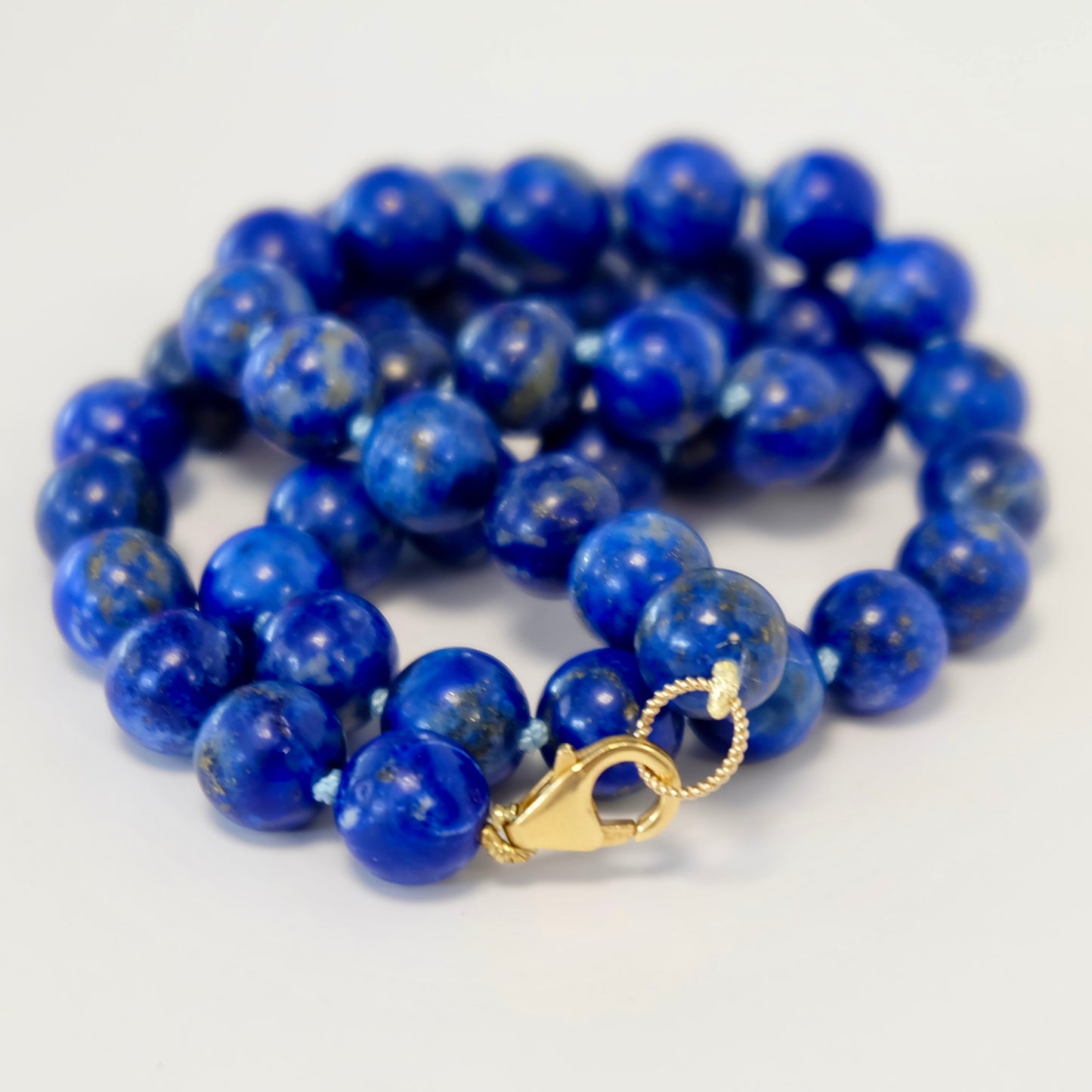 Stunning lapis bead necklace with intricate knots, displaying a striking blue color and a chic, handcrafted look.