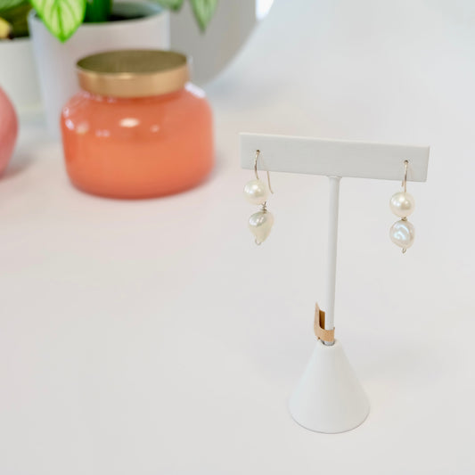 Elegant pearl drop earrings featuring lustrous pearls suspended from delicate metal hooks, perfect for any occasion.