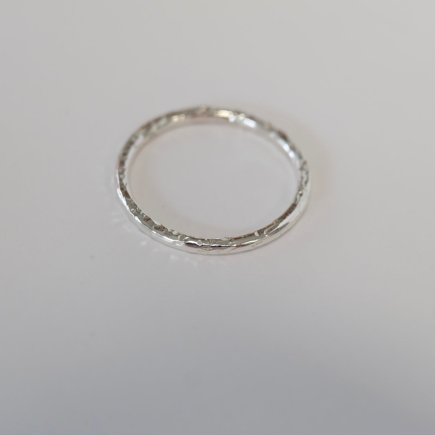 Elegant sterling silver stacking ring, featuring a minimalist design ideal for combining with various styles and other rings.