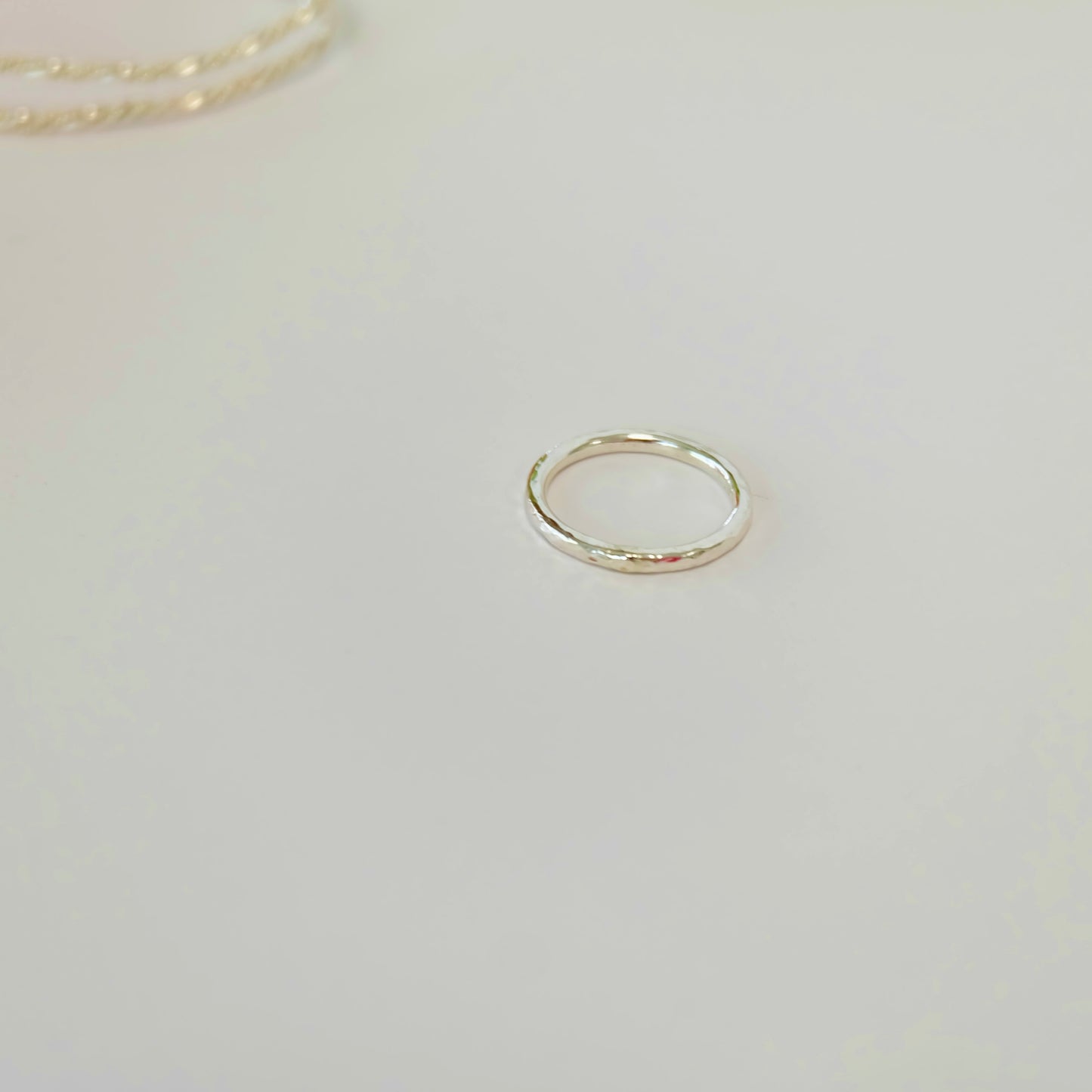 A delicate sterling silver stacking ring, showcasing a sleek and modern design, perfect for layering with other rings.