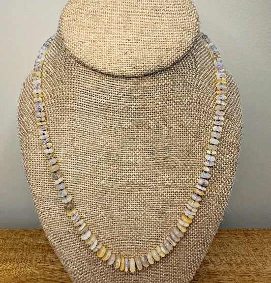 An elegant opal beaded necklace showcasing luminous opal beads, creating a captivating and colorful accessory.