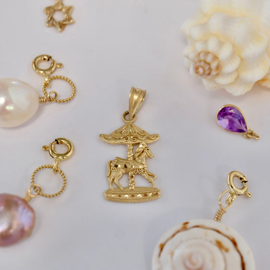  Enchanting 14K Gold Carousel Charm, a whimsical jewelry piece that evokes joyful memories and adds a magical touch.