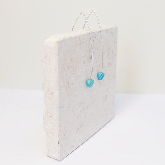 Stunning silver threader earrings featuring turquoise hearts, ideal for a chic and stylish accessory choice.