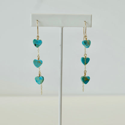 Kingman turquoise heart dangle earrings displayed on white background 