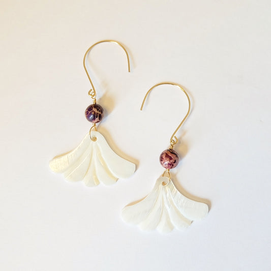 Elegant mother of pearl dangle earrings featuring a shimmering finish, perfect for adding sophistication to any outfit.