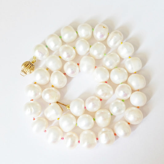 Elegant pearl beaded necklace showcasing lustrous pearls hand knotted together, perfect for enhancing any outfit's sophistication.