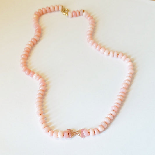 A delicate pink opal bead necklace featuring smooth, polished beads that exude elegance and charm.
