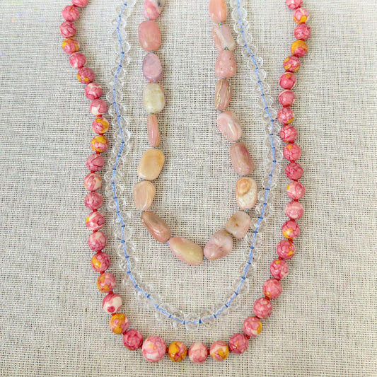 A delicate pink opal bead necklace featuring smooth, polished stones strung together for an elegant look.