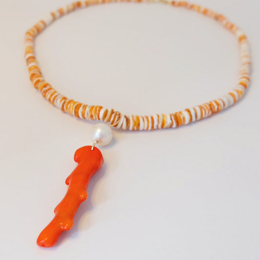 Spiny Oyster Shell Necklace showcasing a coral and pearl charm, embodying nature's elegance and artistic craftsmanship.