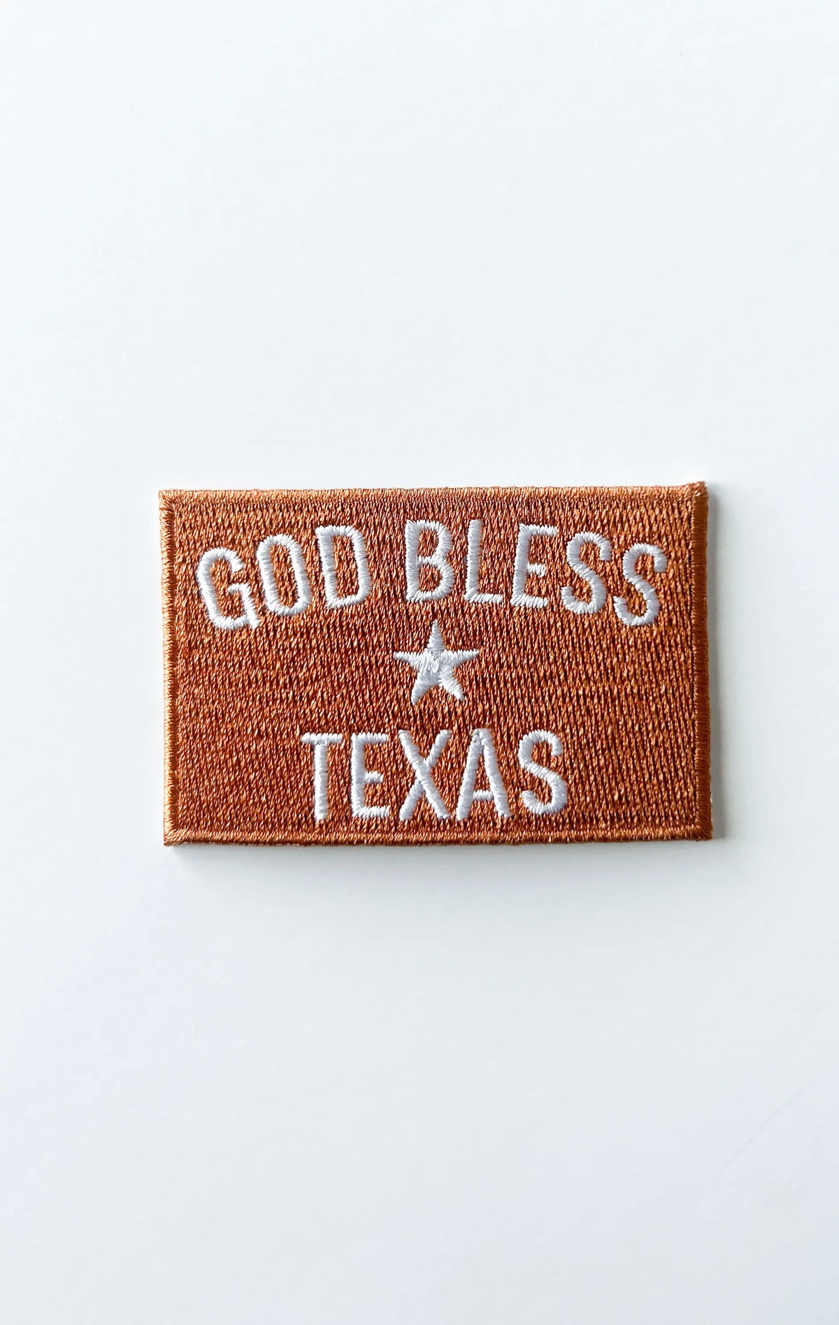 Embroidered patch with 'God Bless Texas' text on a white background
