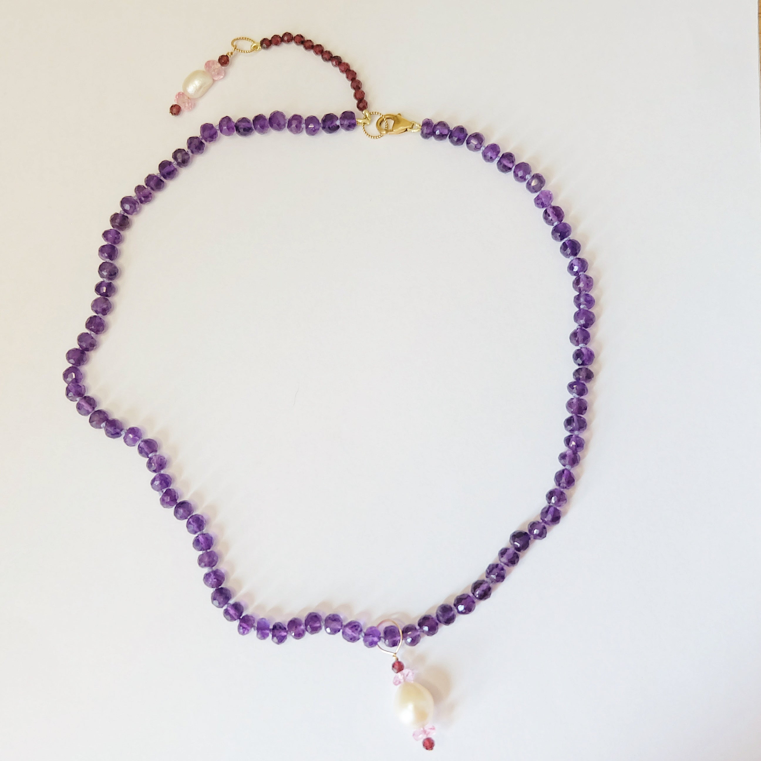 Amethyst bead necklace with pearl, pink topaz, and garnet charms