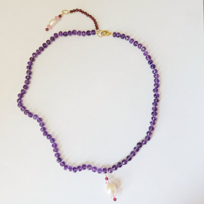 Amethyst bead necklace with pearl, pink topaz, and garnet charms
