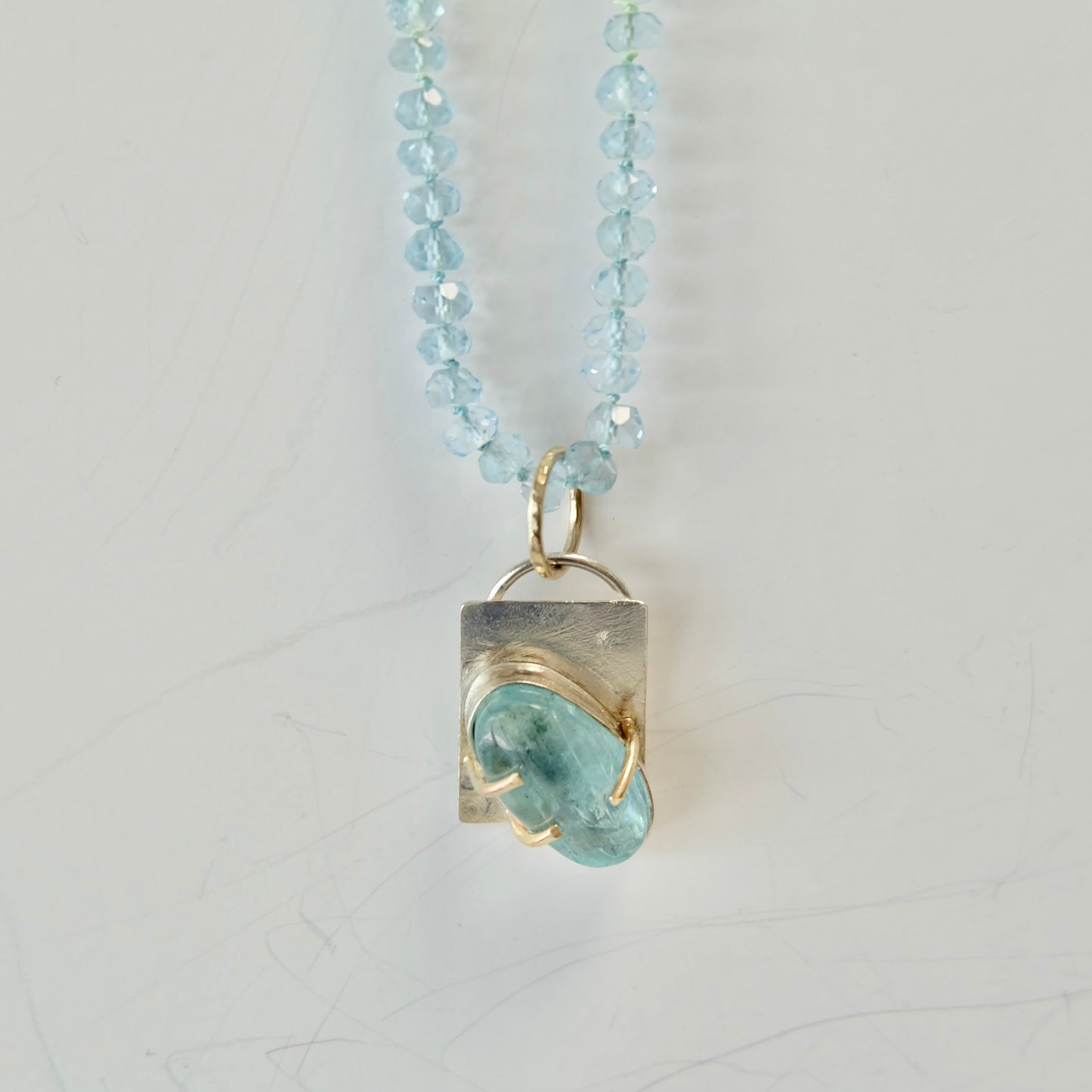 Close-up of Aquamarine Charm Necklace showcasing the 14K gold clasp and smooth aquamarine beads.
