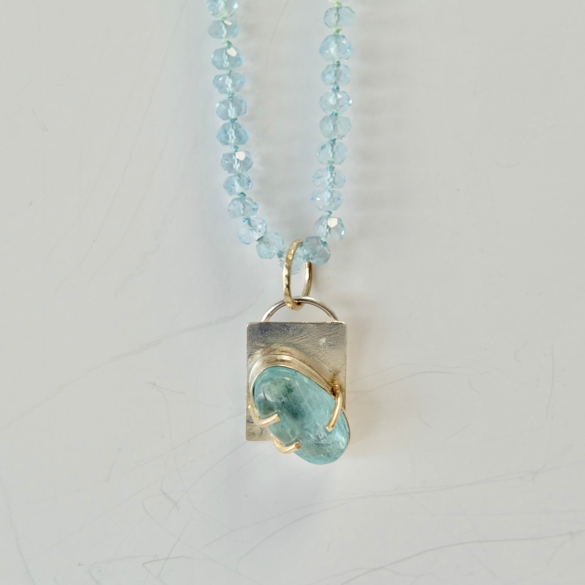 Close-up of Aquamarine Charm Necklace showcasing the 14K gold clasp and smooth aquamarine beads.