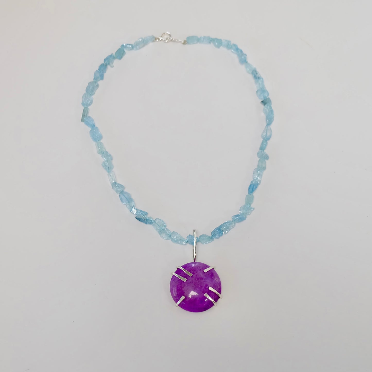 Vibrant aquamarine necklace with purple sugilite pendant