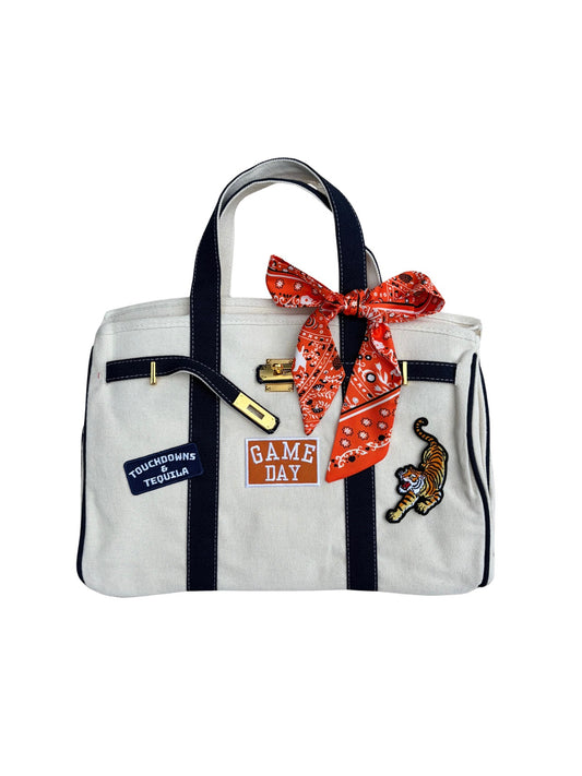 Auburn college football tote bag featuring an orange twilly scarf, gold lock, and custom Auburn Tiger patches.