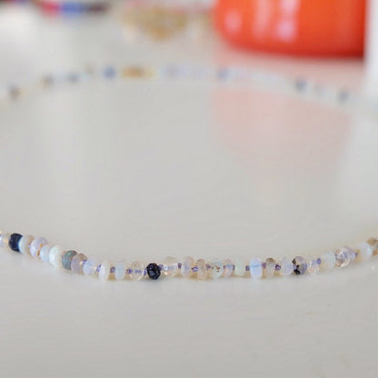 Close-up of Australian opal beads hand-knotted on lavender silk