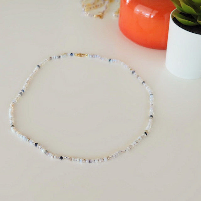 Australian opal bead necklace on a stand showing deep blue and fiery red opal